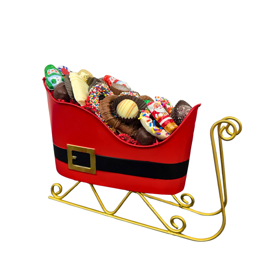 Decorative holiday sled gift filled with assorted chocolate truffles Dolce Confections Hewlett NY