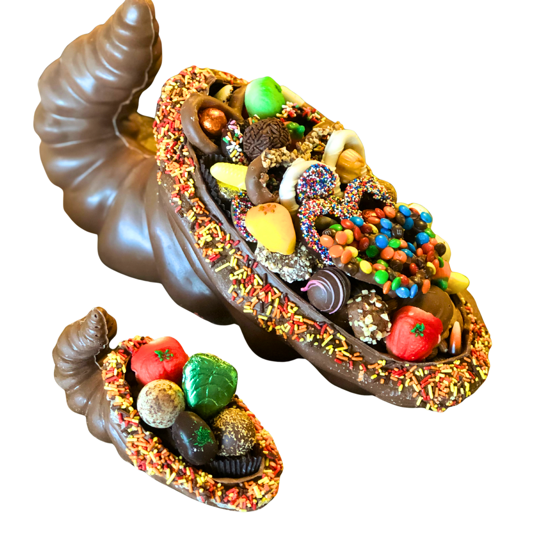 Milk chocolate cornucopia filled with assorted truffles and foiled chocolates, autumn table centerpiece.