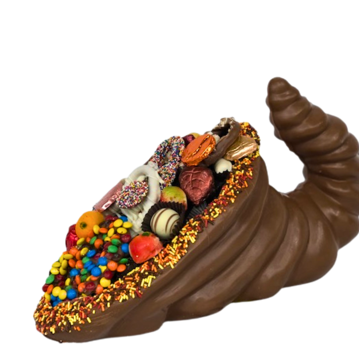 Dark/pareve chocolate cornucopia overflowing with marzipan and fall-themed treats, kosher certified.