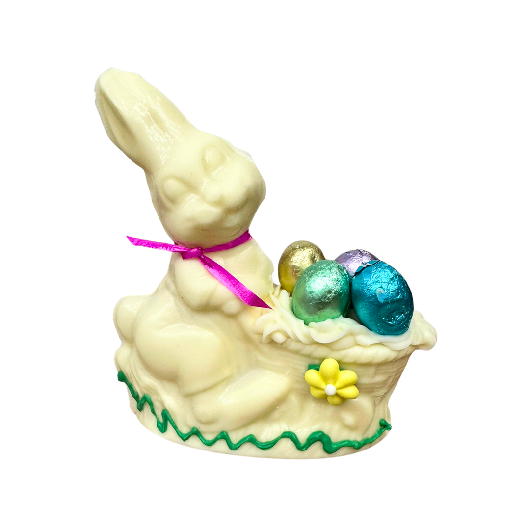 Handcrafted chocolate bunny with decorative Easter wheelbarrow and chocolate eggs