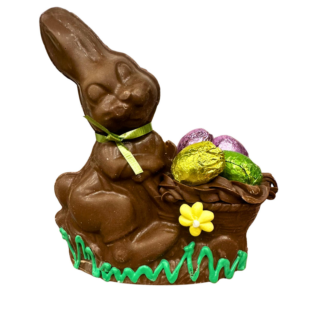 Milk chocolate Easter bunny wheelbarrow filled with colorful foil eggs